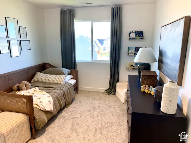 Neutral wall color with recessed lighting, complemented by a large window with full-length drapery
