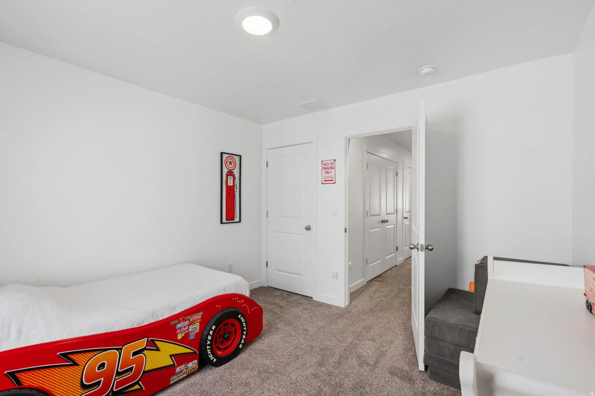 White walls, white doors, and light gray carpet create a neutral backdrop