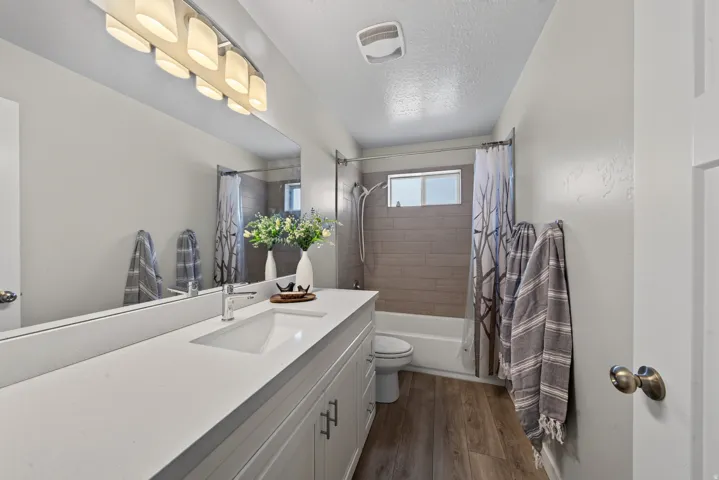 Shared bathroom. Spacious vanity with an integrated sink and chrome faucet