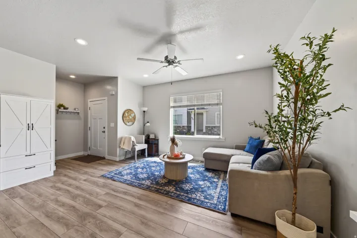 Wood-finish flooring, recessed lighting, and a ceiling fan