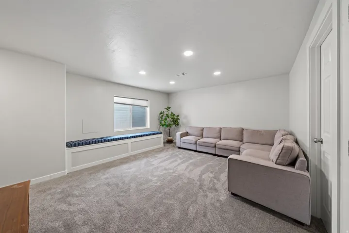 Recessed lighting, built-in window bench, carpeted flooring, and white interior doors