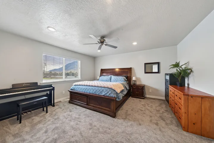 Recessed lighting, ceiling fan, carpeting, and a window with mountain scenery
