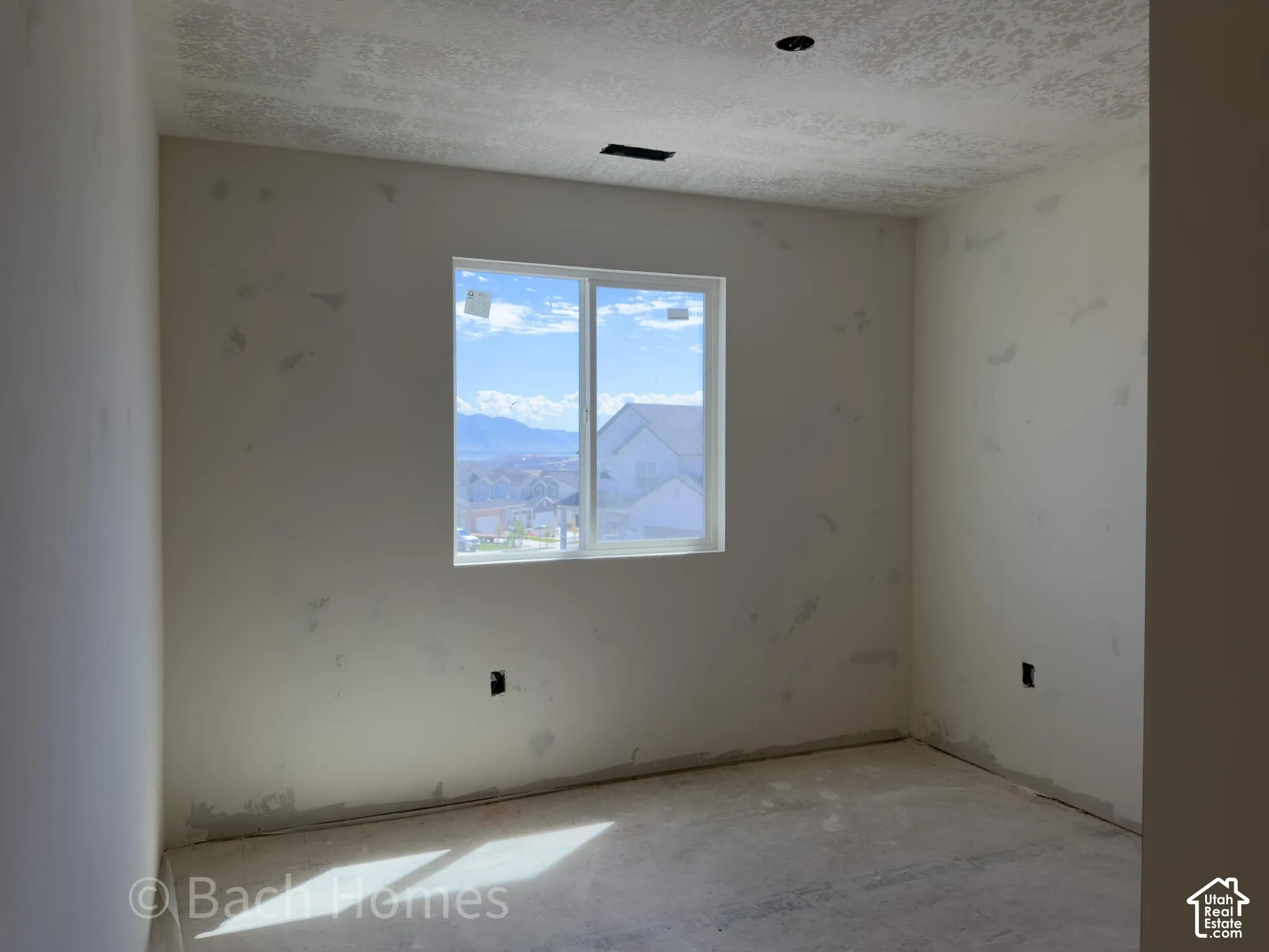 Recessed lighting, singular window, mountain backdrop