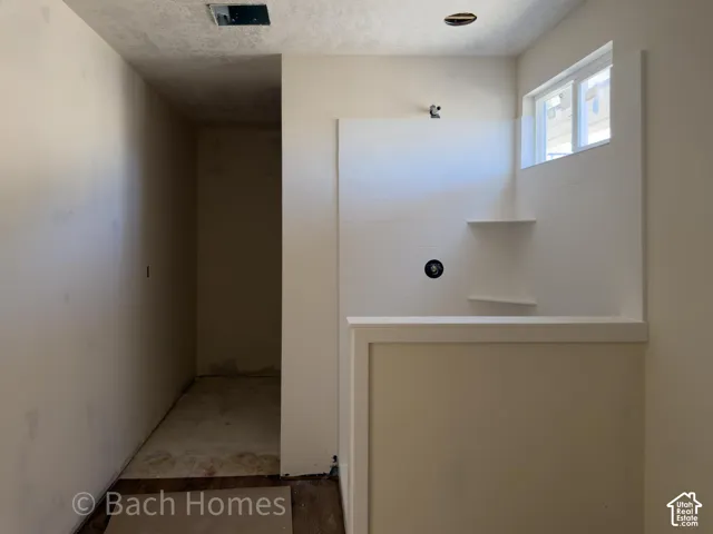 Tiled shower enclosure with built-in shelving, a window, and a shower fixture