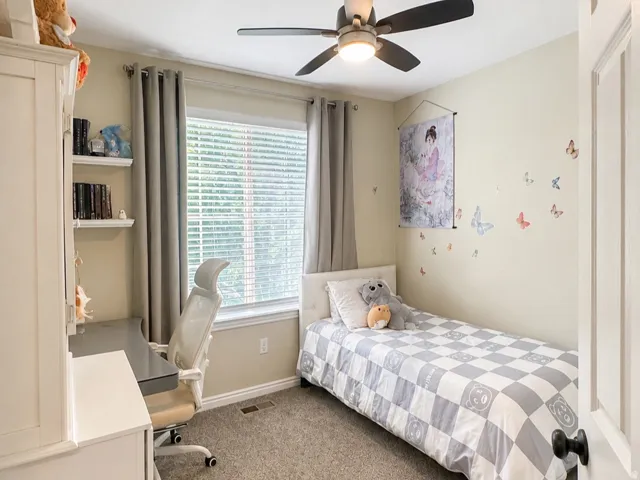 Recessed lighting, wood-finish ceiling fan, white paneled door, and carpeted flooring