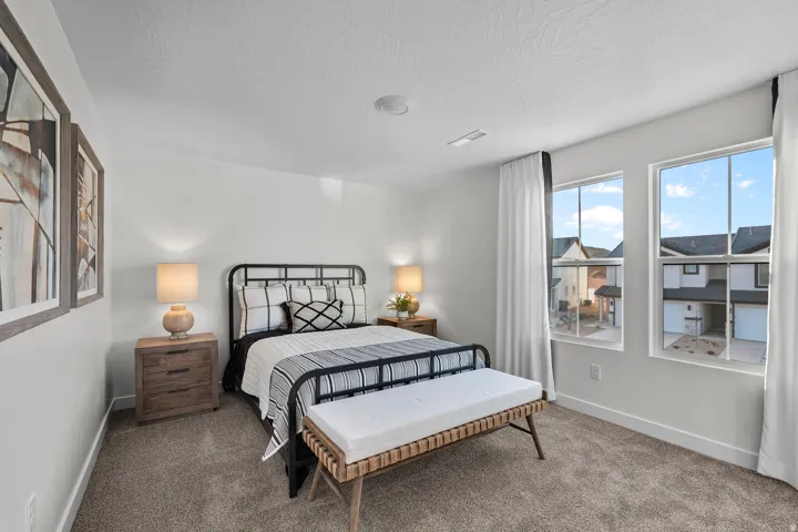 Carpeted flooring, white walls, and two large windows with white trim