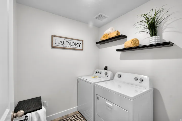 Utility space featuring white walls, recessed lighting, and wood-finish flooring