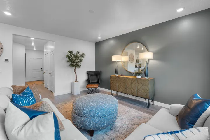 Wood-finish flooring, recessed lighting, and a console table with geometric detailing