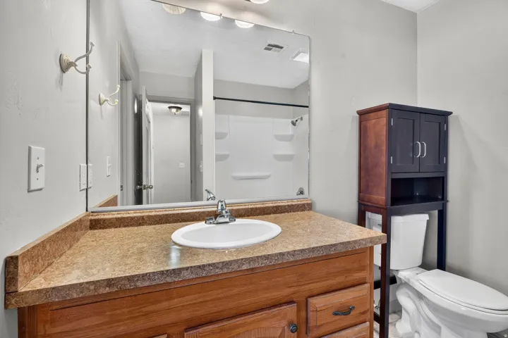 Wood-finish vanity with an integrated sink and laminate countertop