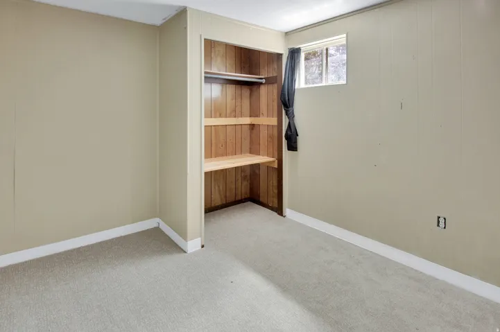 Built-in closet with wood paneling and shelving