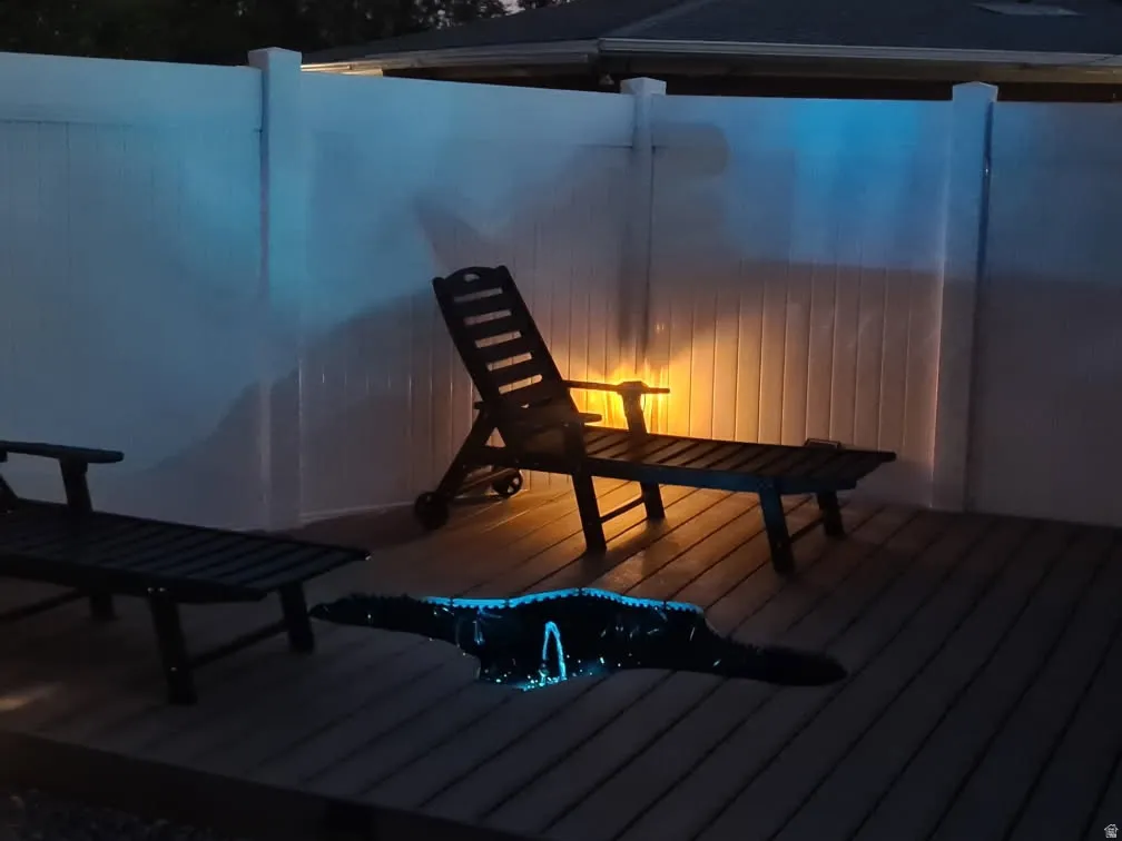 Deck space featuring composite decking and a white privacy fence