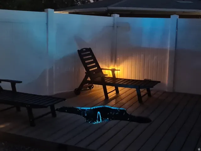 Deck space featuring composite decking and a white privacy fence