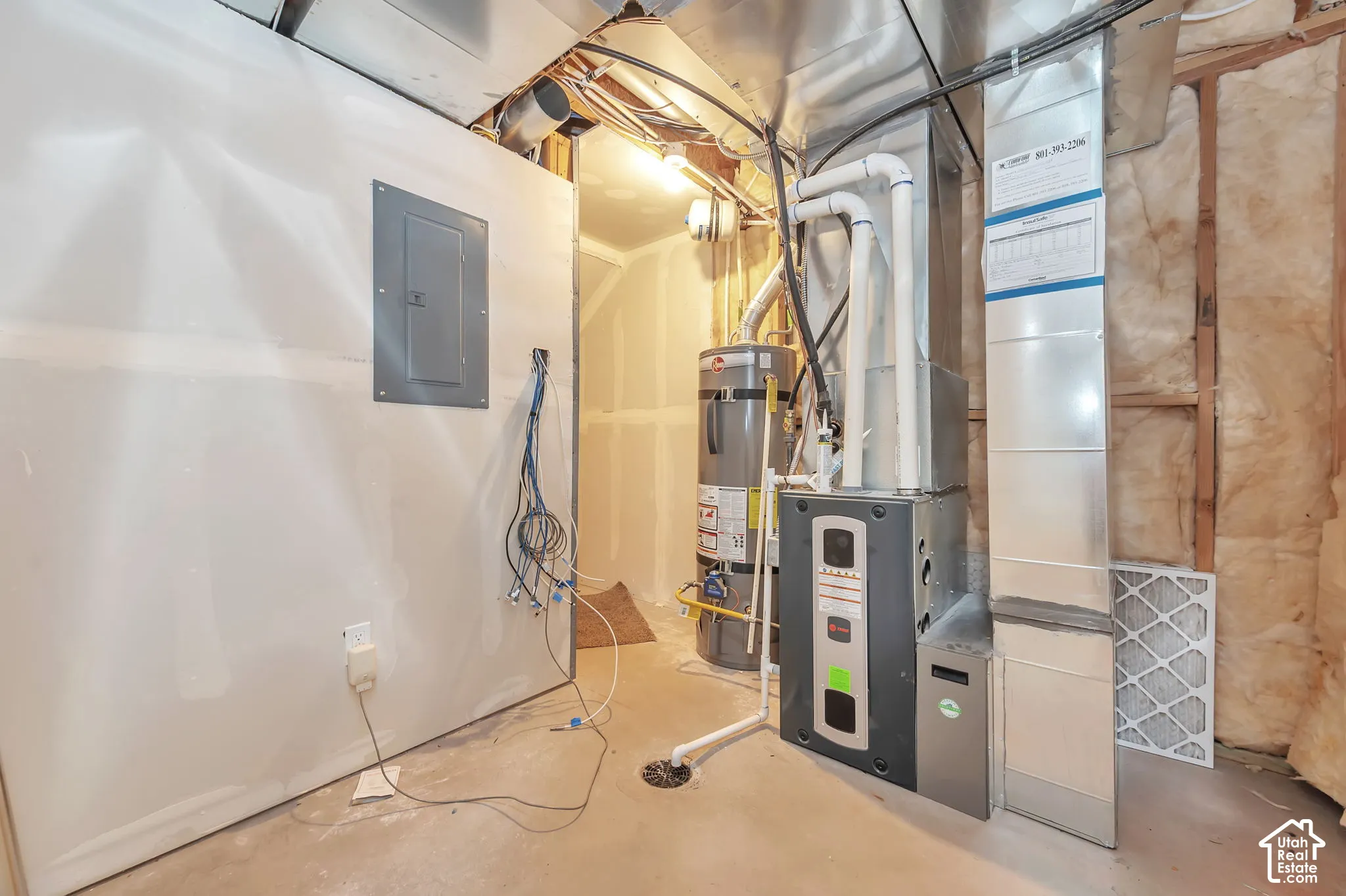 Furnace system, water heater, exposed ductwork, and electrical panel