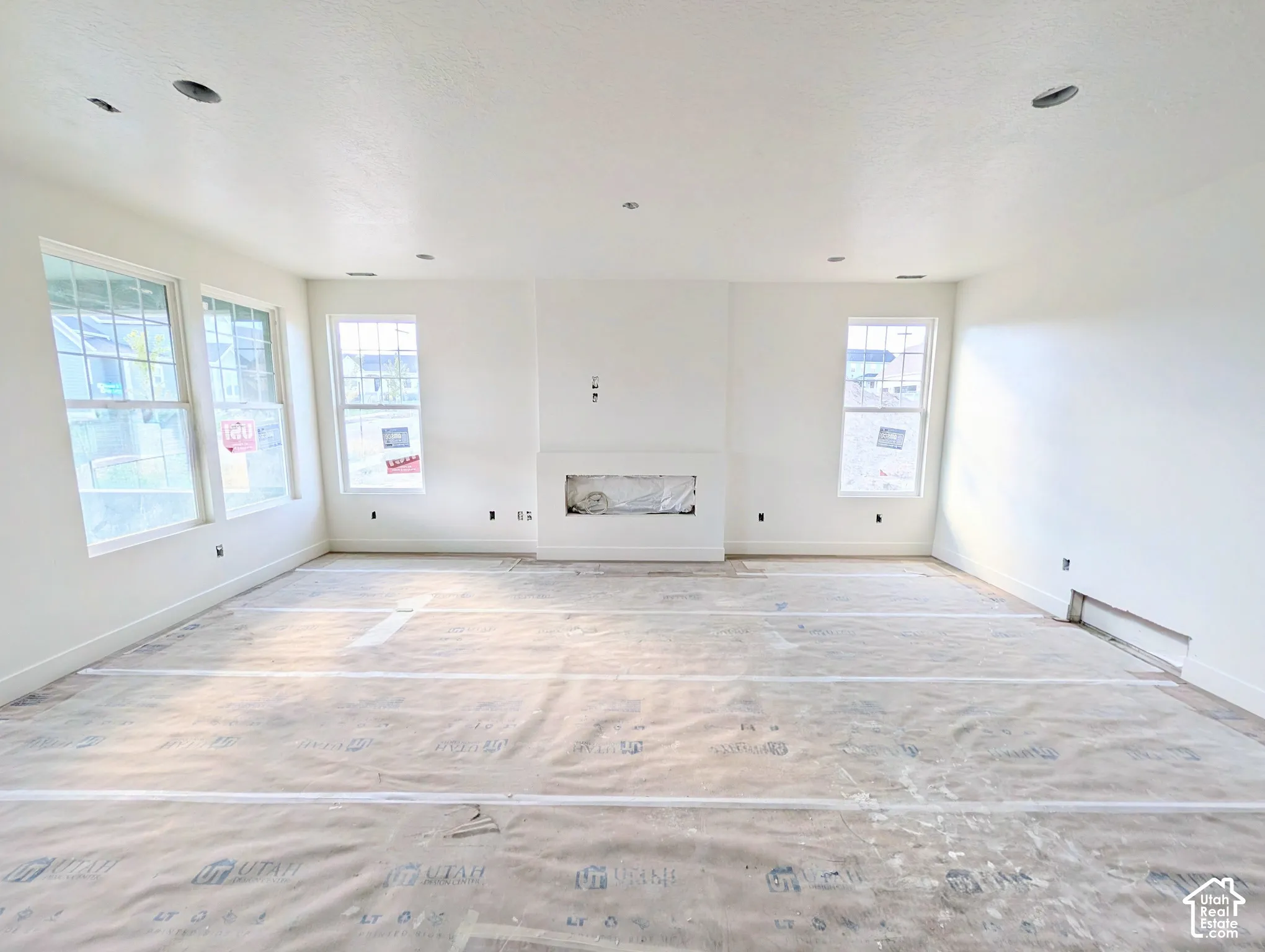 Recessed lighting, multiple windows, and a built-in fireplace feature