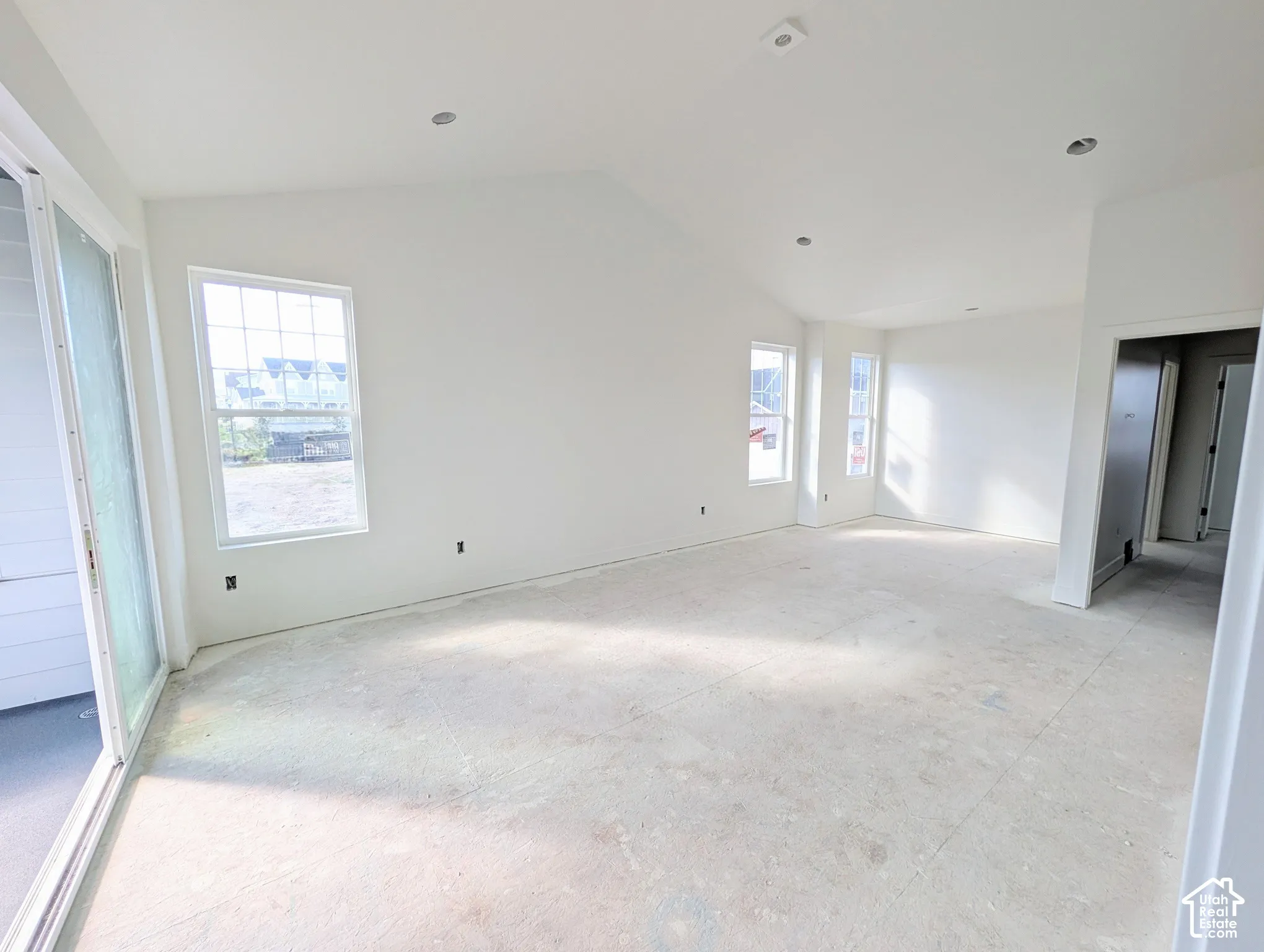Primary bedroom with Vaulted ceiling with recessed lighting