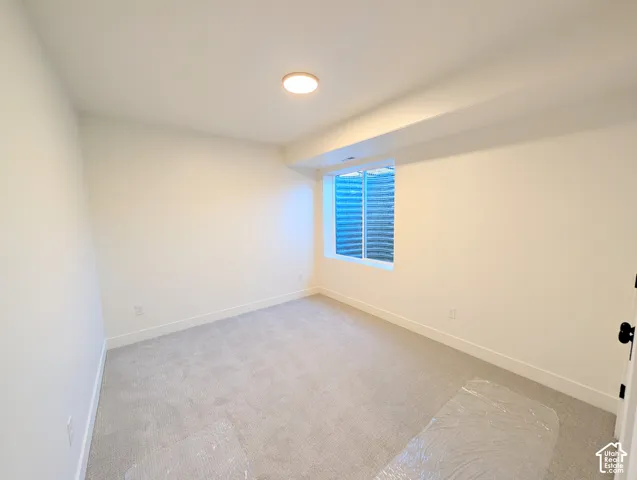 Bright secondary bedroom with recessed ceiling lighting, neutral wall finishes, and carpet flooring