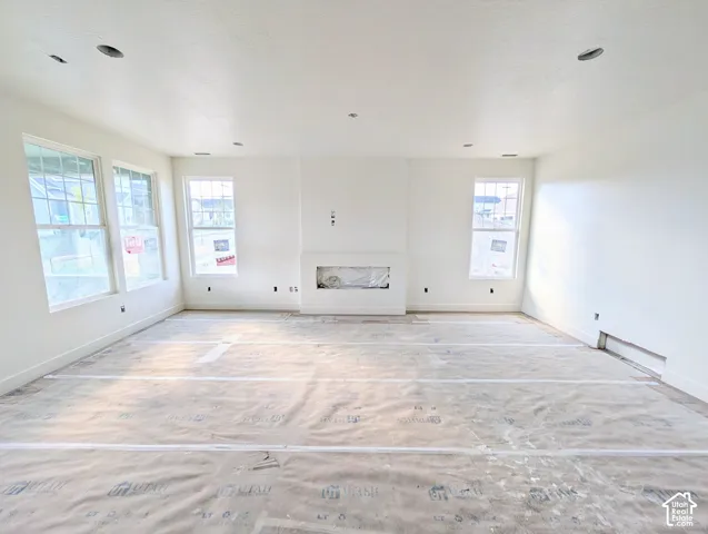 Recessed lighting, multiple windows, and a built-in fireplace feature