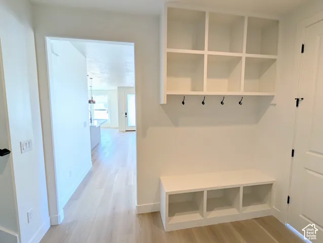 Built-in entryway storage with bench seating, cubbies, and coat hooks