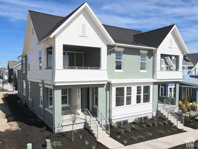Contemporary multi-story exterior with a covered balcony, front porch, and modern railing system