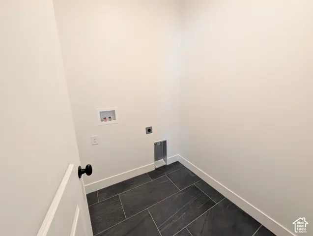 Dark large-format tile flooring and light-toned walls
