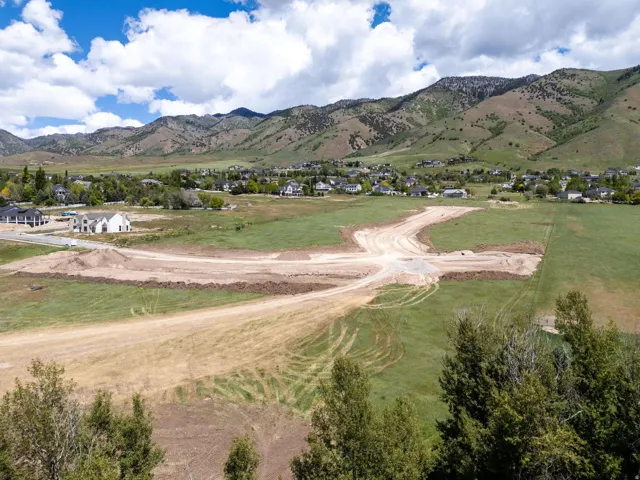 Expansive lot with mountain backdrop, surrounded by established residential properties