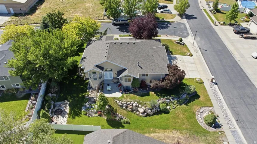 Manicured lawn with mature trees and rock landscaping