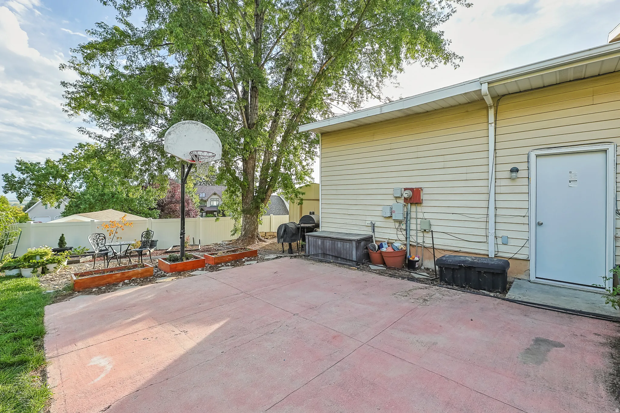 Expansive concrete patio with basketball hoop