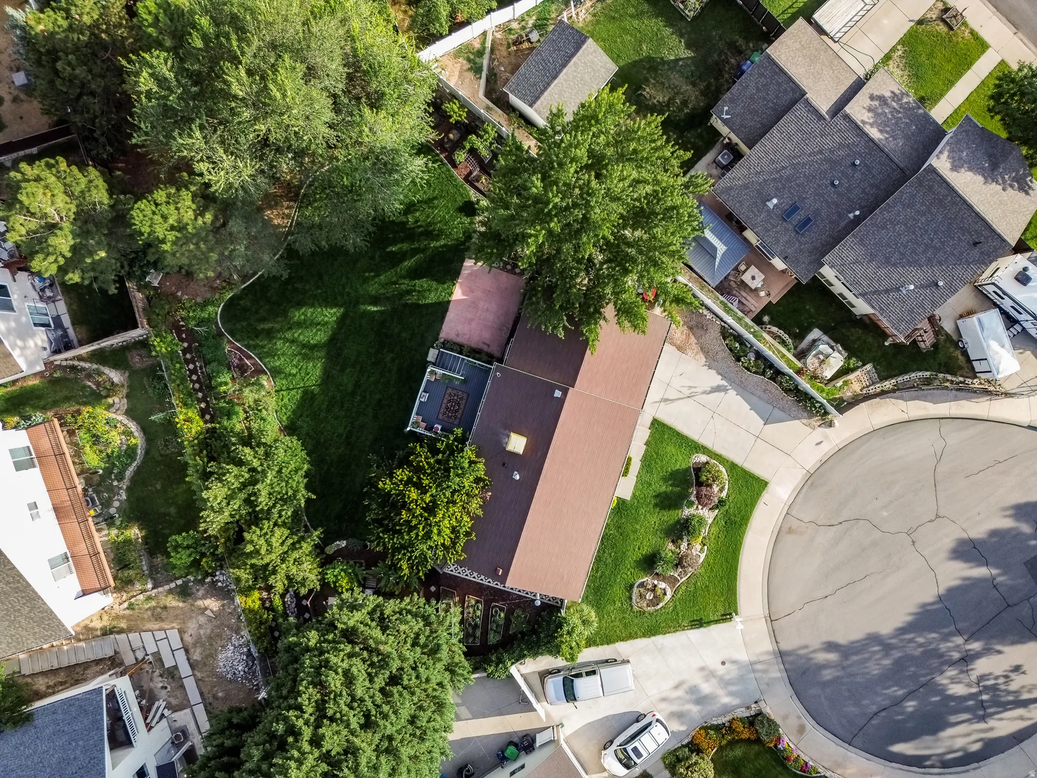 Expansive lot featuring a large lawn, mature trees, a multi-level deck, and a cul-de-sac location