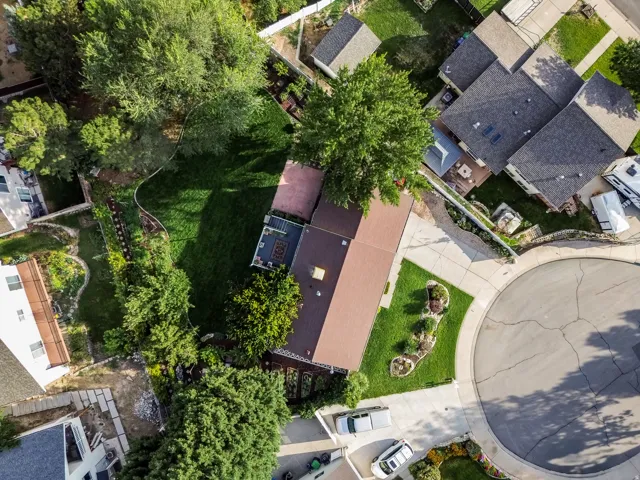 Expansive lot featuring a large lawn, mature trees, a multi-level deck, and a cul-de-sac location