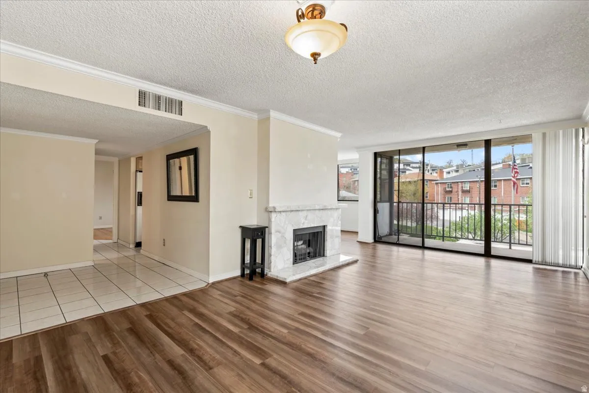 Wood-finish flooring throughout the main living area, complemented by a white tile entry