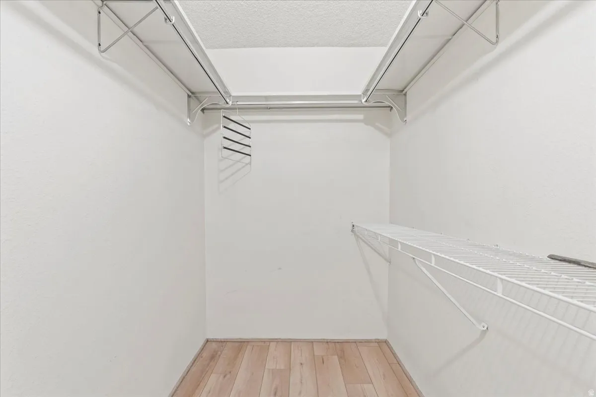White wire shelving, white walls, and wood-finish flooring