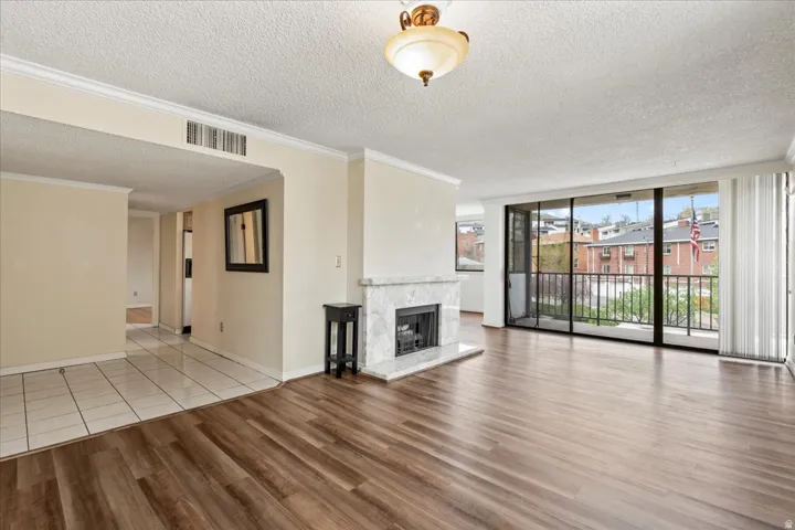 Wood-finish flooring throughout the main living area, complemented by a white tile entry