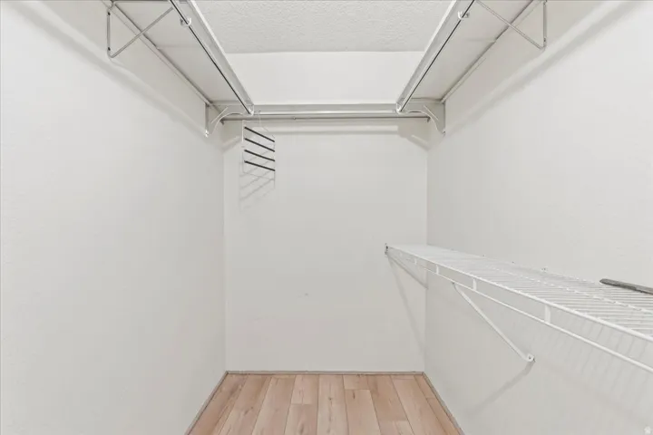 White wire shelving, white walls, and wood-finish flooring