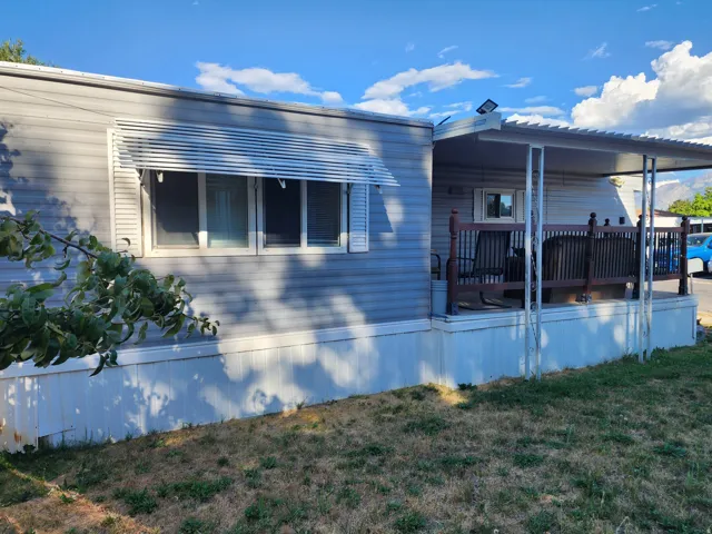 Siding exterior with a covered porch and deck