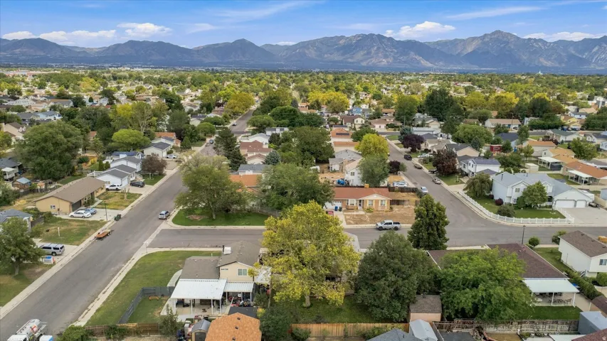 Aerial view showcasing this residential property situated on a tree-lined street within an established neighborhood