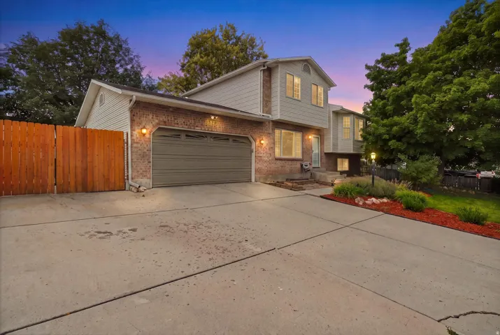 Two-story home with brick and siding exterior, featuring a two-car attached garage with dark finish doors