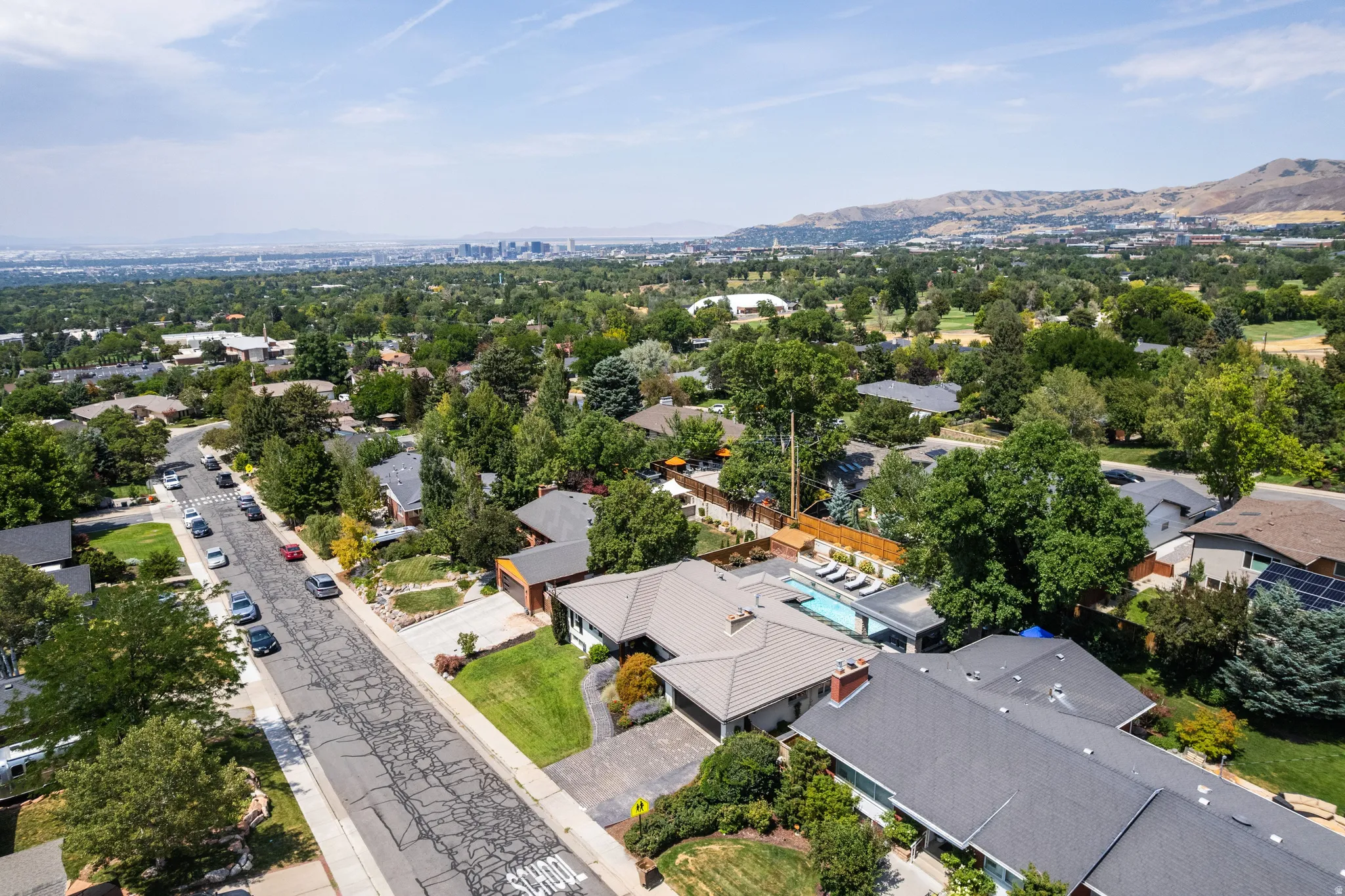 Expansive property featuring a private swimming pool, mature landscaping, and a multi-car driveway