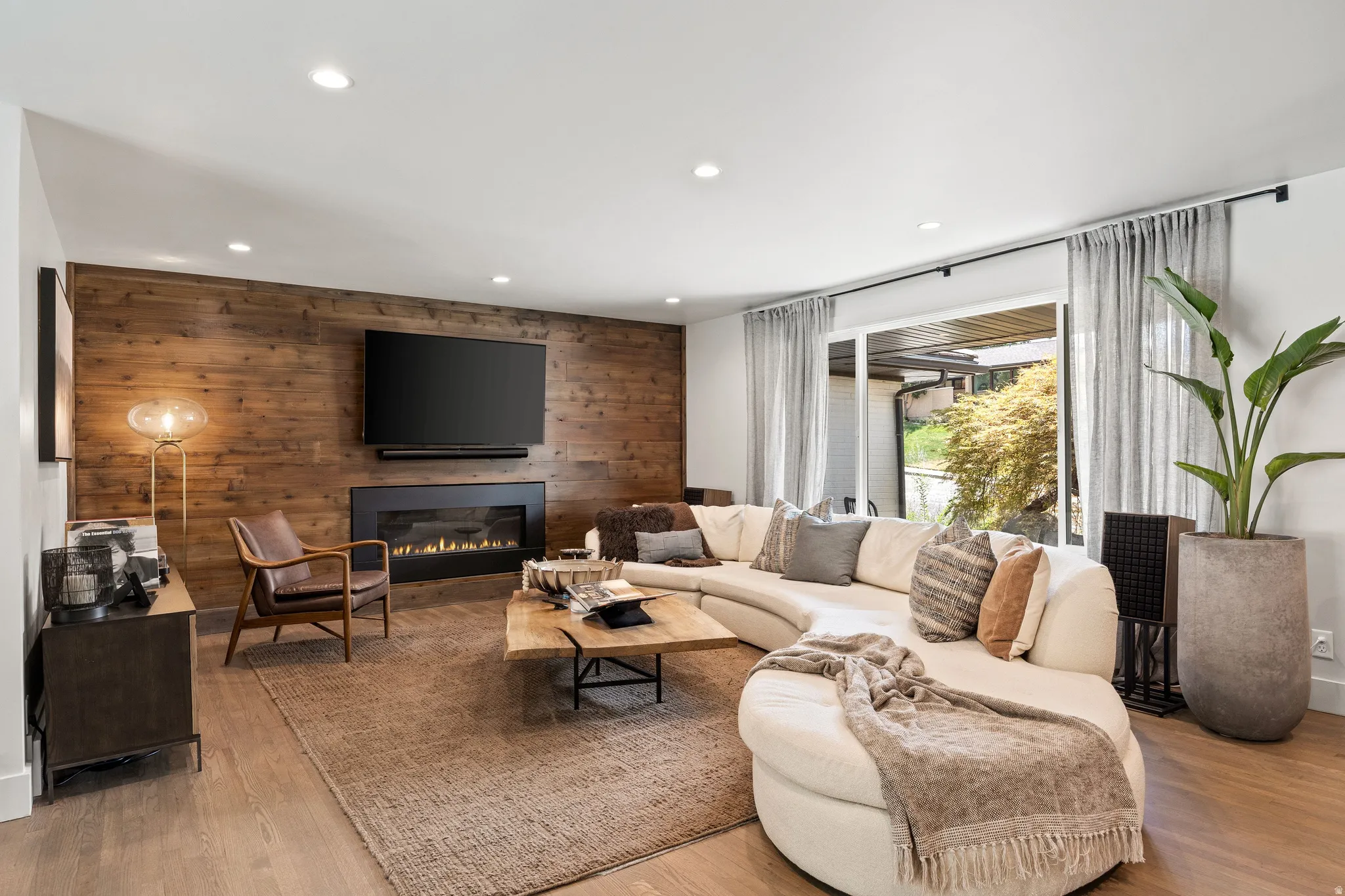 Wood-plank accent wall with a built-in linear fireplace
