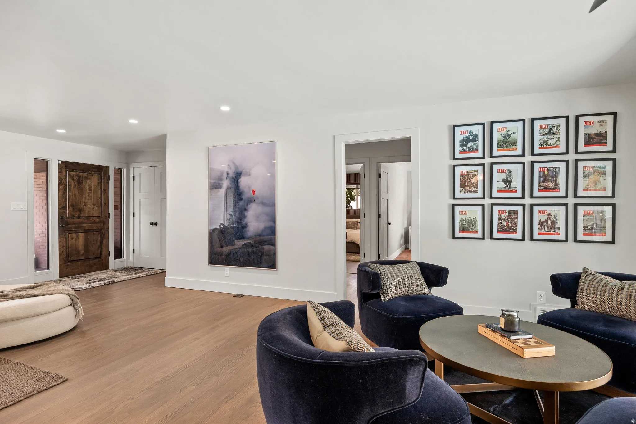 Recessed lighting illuminates wood-finish flooring