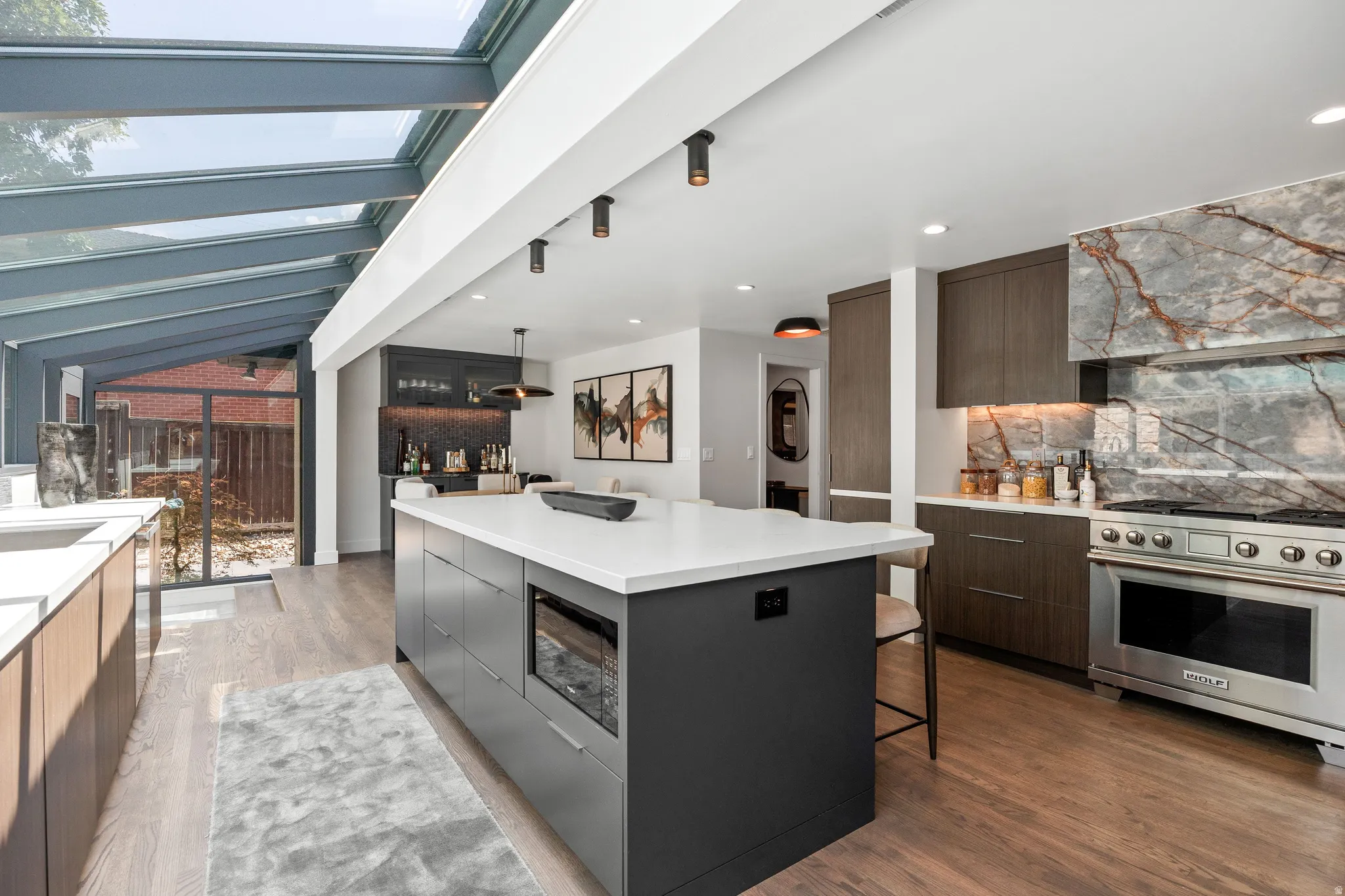 Gourmet kitchen featuring a large central island, stainless steel range, and custom cabinetry