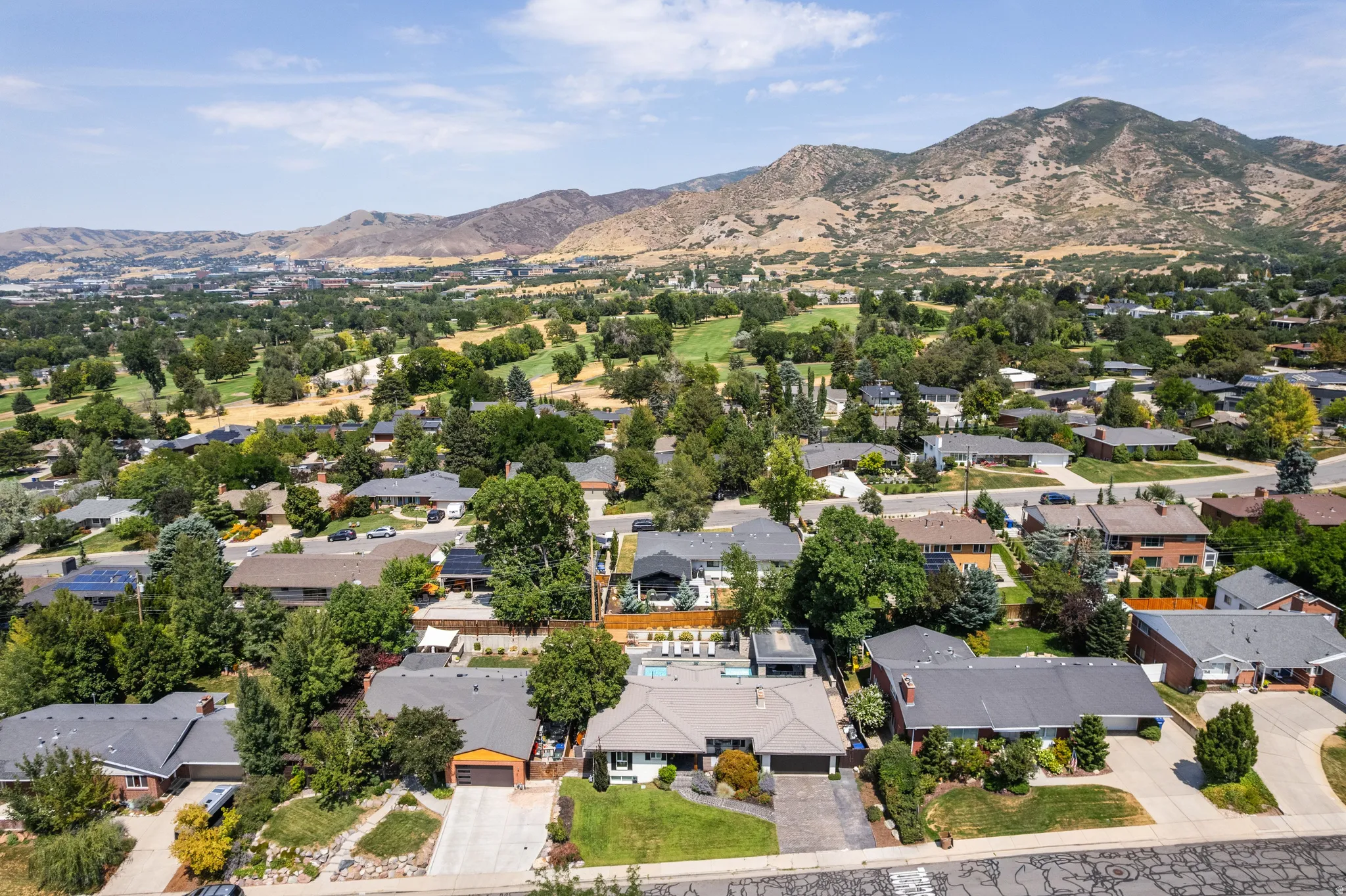 Residential neighborhood featuring mature trees and a golf course