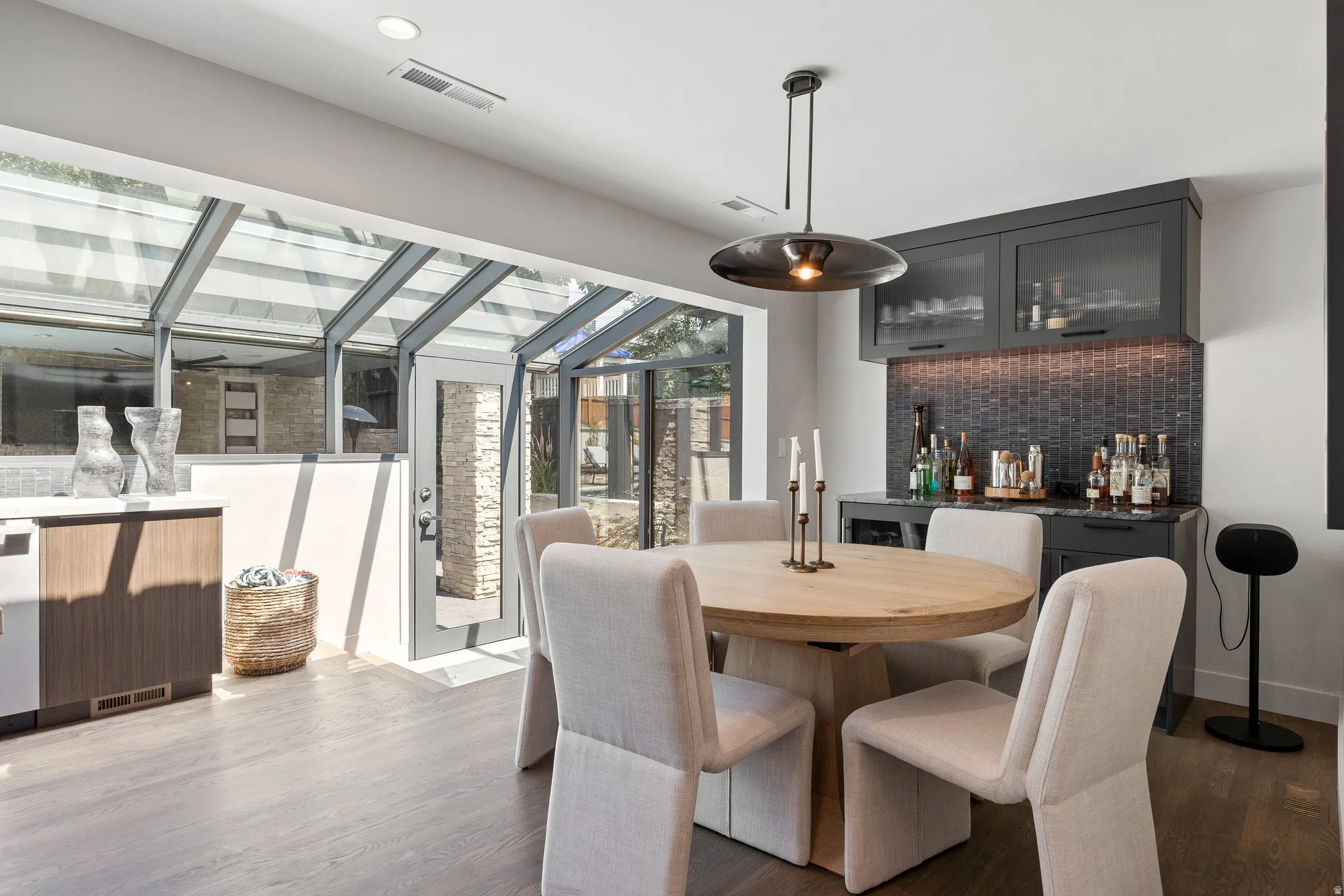 Integrated sunroom with glass ceiling and exterior access