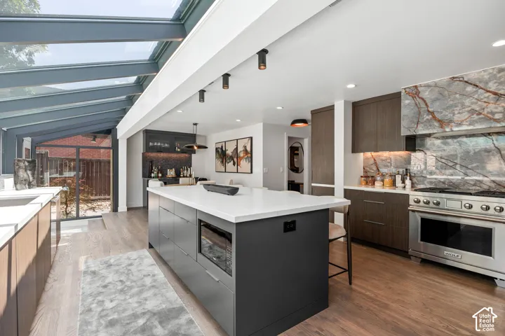Gourmet kitchen with a large central island, stainless steel range, and custom cabinetry