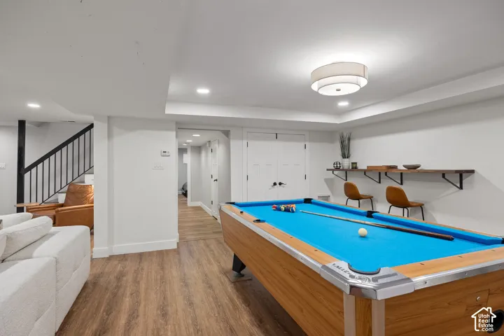 Recreation space featuring a pool table, wood-finish flooring, recessed lighting, a modern drum light fixture, and a built-in wall shelf