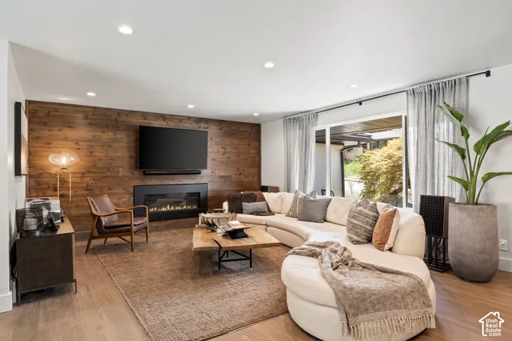 Hardwood-finish flooring throughout, featuring a natural wood accent wall with a built-in fireplace