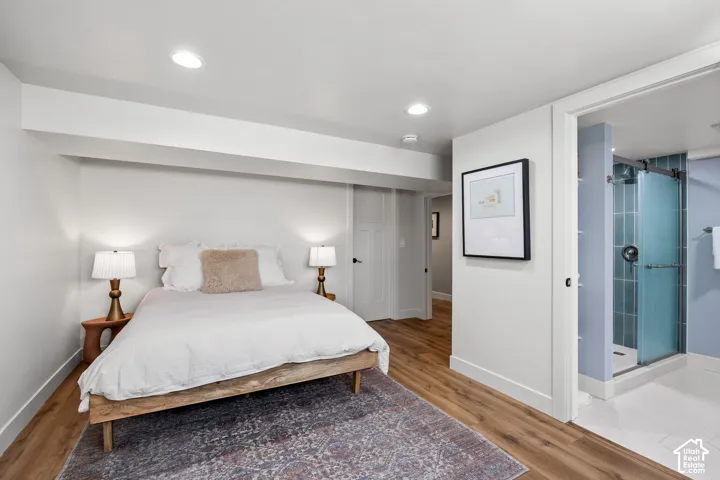 Wood-finish flooring, recessed lighting, and white walls