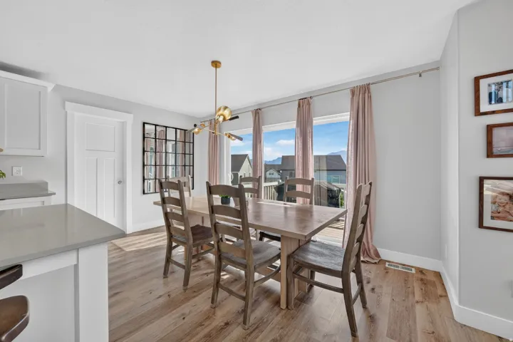 Open concept dining area with wood-finish flooring