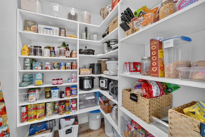 Expansive pantry featuring white shelving, multiple storage levels, and built-in organization