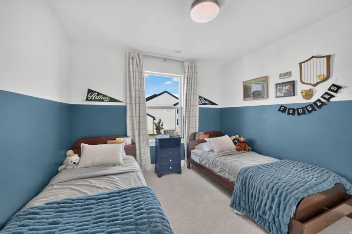 Recessed lighting, light-toned carpeting, and a window with natural light