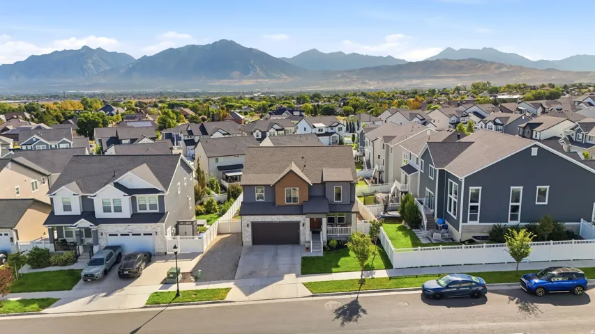 Modern architectural style with a two-car garage, concrete driveway, and front landscaping
